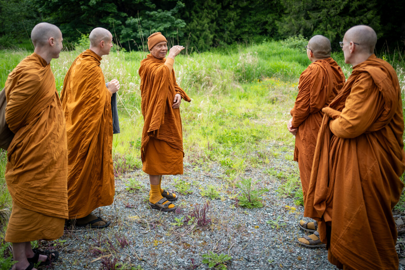 Luang Por Jundee converses with monastics on a land excursion near Cougar Mountain