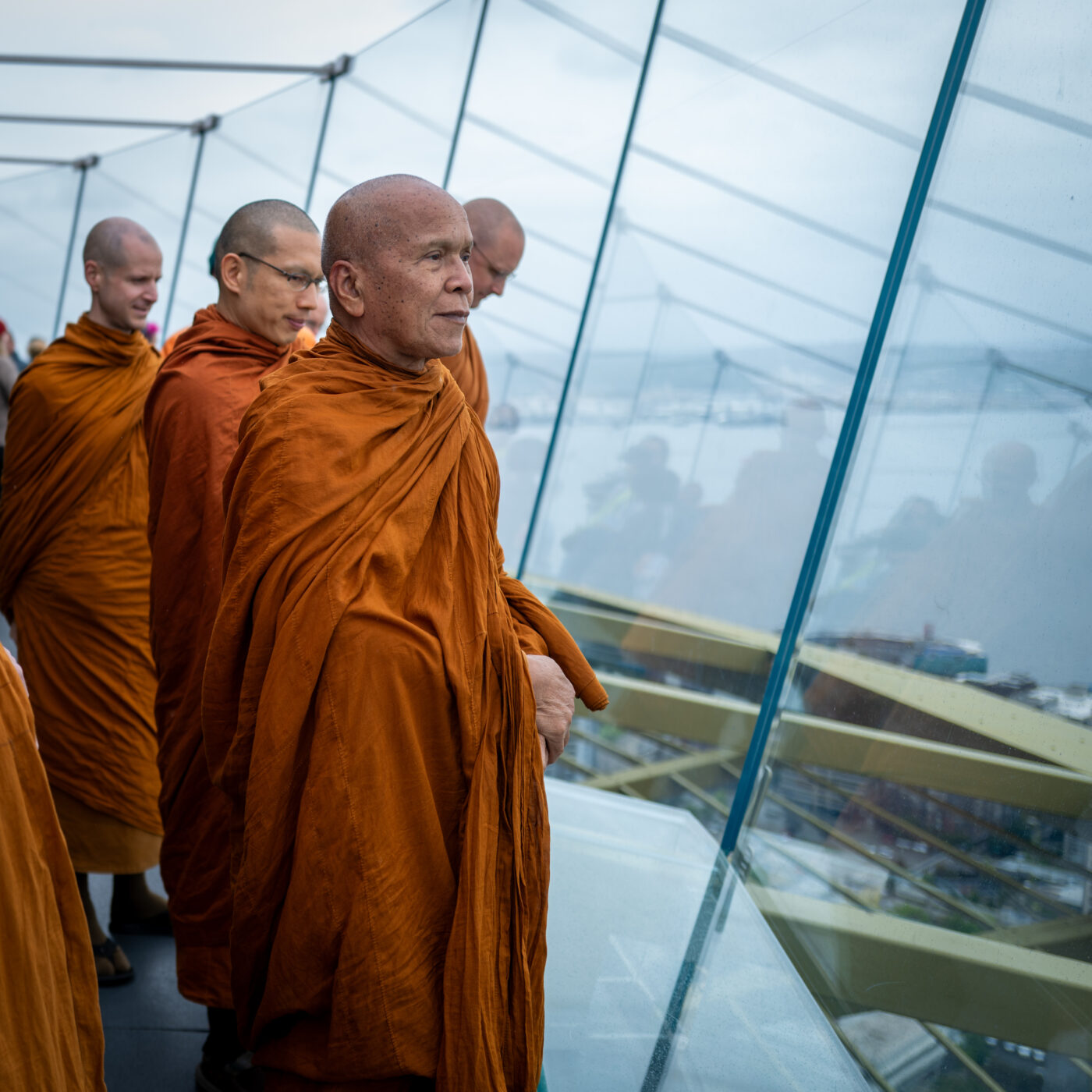 Krooba Ajahn Jundee looks out onto a panoramic view of Seattle from the city's Space Needle viewpoint