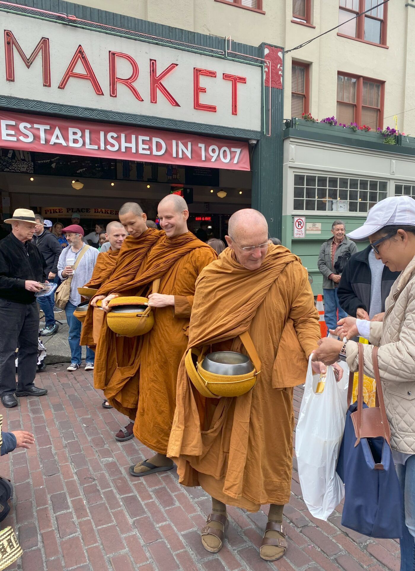 Luang Por Pasanno leading alms round through Pike Place Market